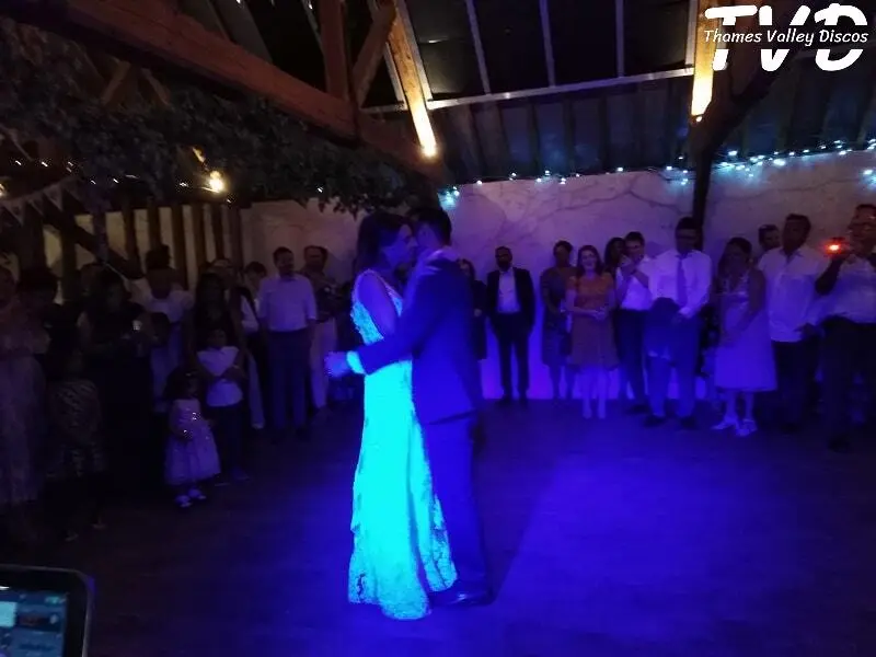 bride and groome dancing with guests looking on